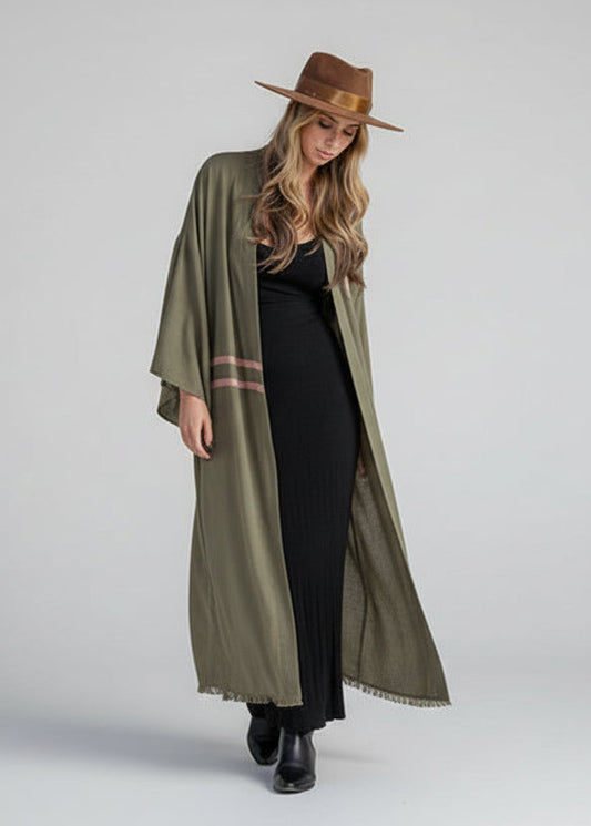 WOMAN WEARING AN OLIVE KIMONO WHICH IS OPEN IN THE FRONT AND SHOWCASING THE HAND PLEATED SLEEVES