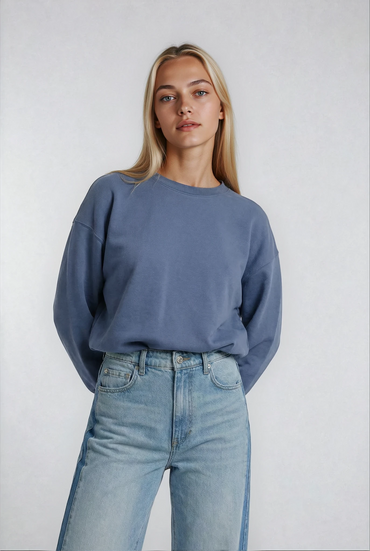 Person wearing a House of Malibu Pacific blue cropped french terry sweatshirt and jeans