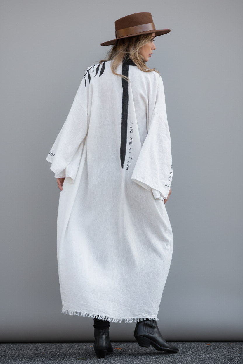 Person wearing a long light-colored kimono coat with black line down the spine alongside quote "take me as i am"