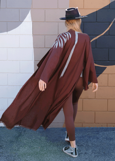 WOMAN WEARING A BROWN KIMONO SHOWING HER BEHIND WITH A STRIPE  HAND-PAINTED DOWN HER SPINE