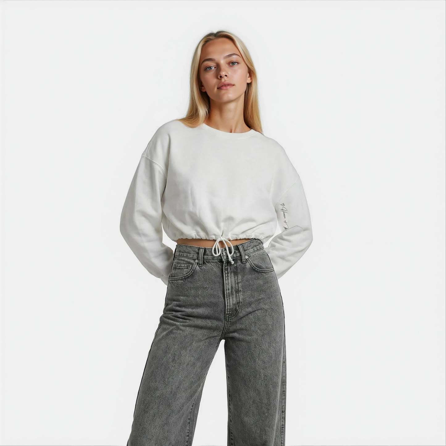 Front Close up view of a woman wearing a white cropped Malibu sweatshirt styled with grey denim — House of Malibu original design