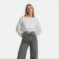 Front Close up view of a woman wearing a white cropped Malibu sweatshirt styled with grey denim — House of Malibu original design