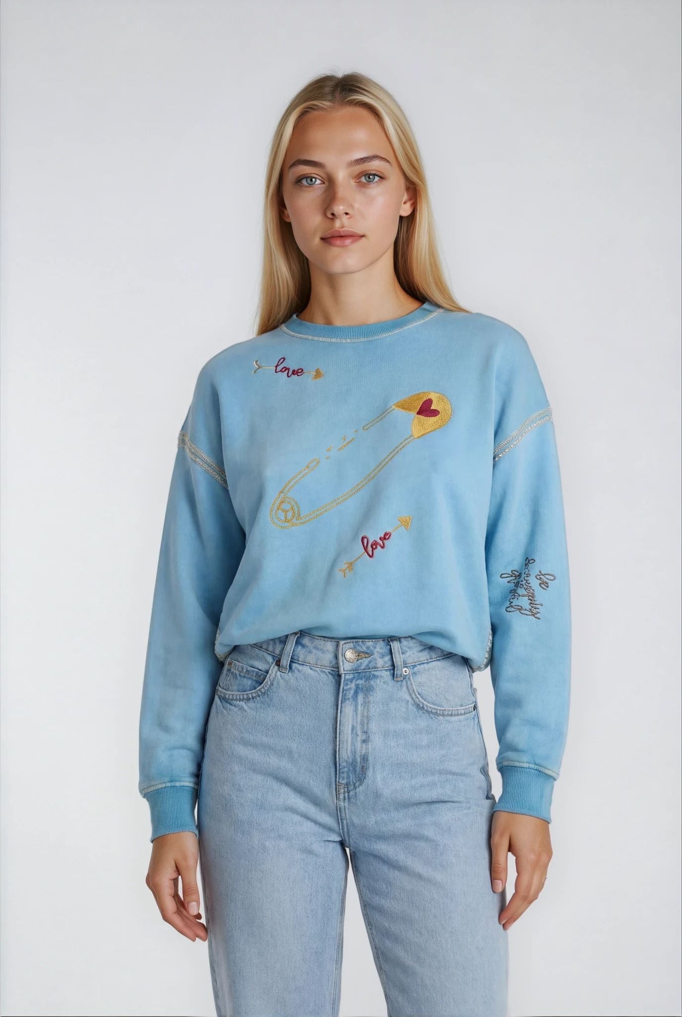 House of Malibu light blue sweatshirt with embroidered hand-painted designs of love and bows and arrows and heart pins