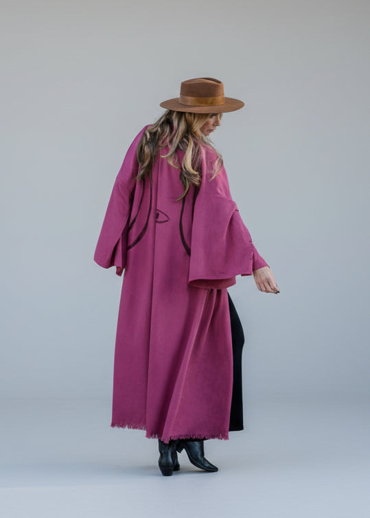 a woman wearing an evil eye hand-painted kimono showing the back 