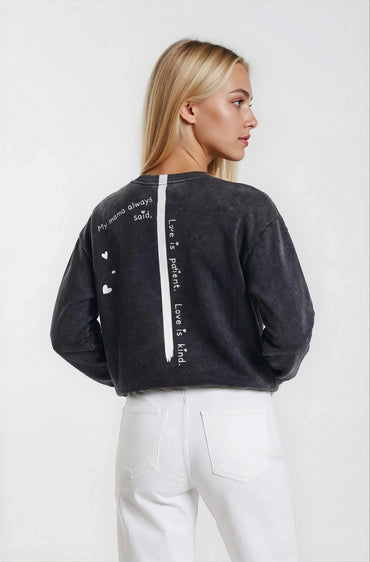 Woman wearing a  House-of-malibu Onyx sweatshirt with hand-painted quote and stripe down the back 