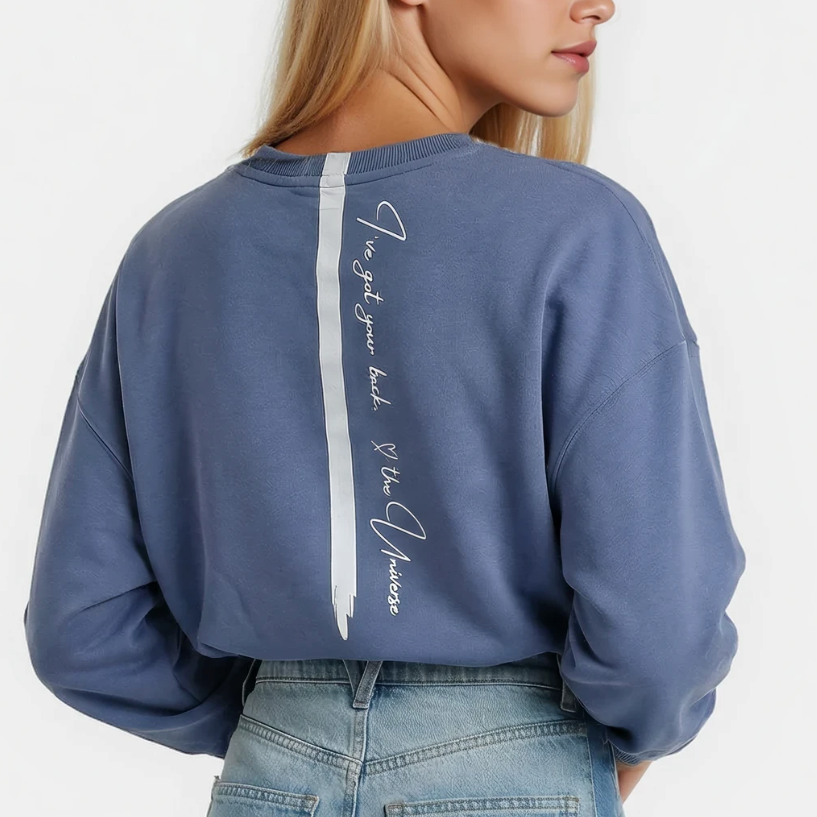 Pacific Blue sweatshirt with Affirmation quote text on the back down the spine  worn by a blonde woman