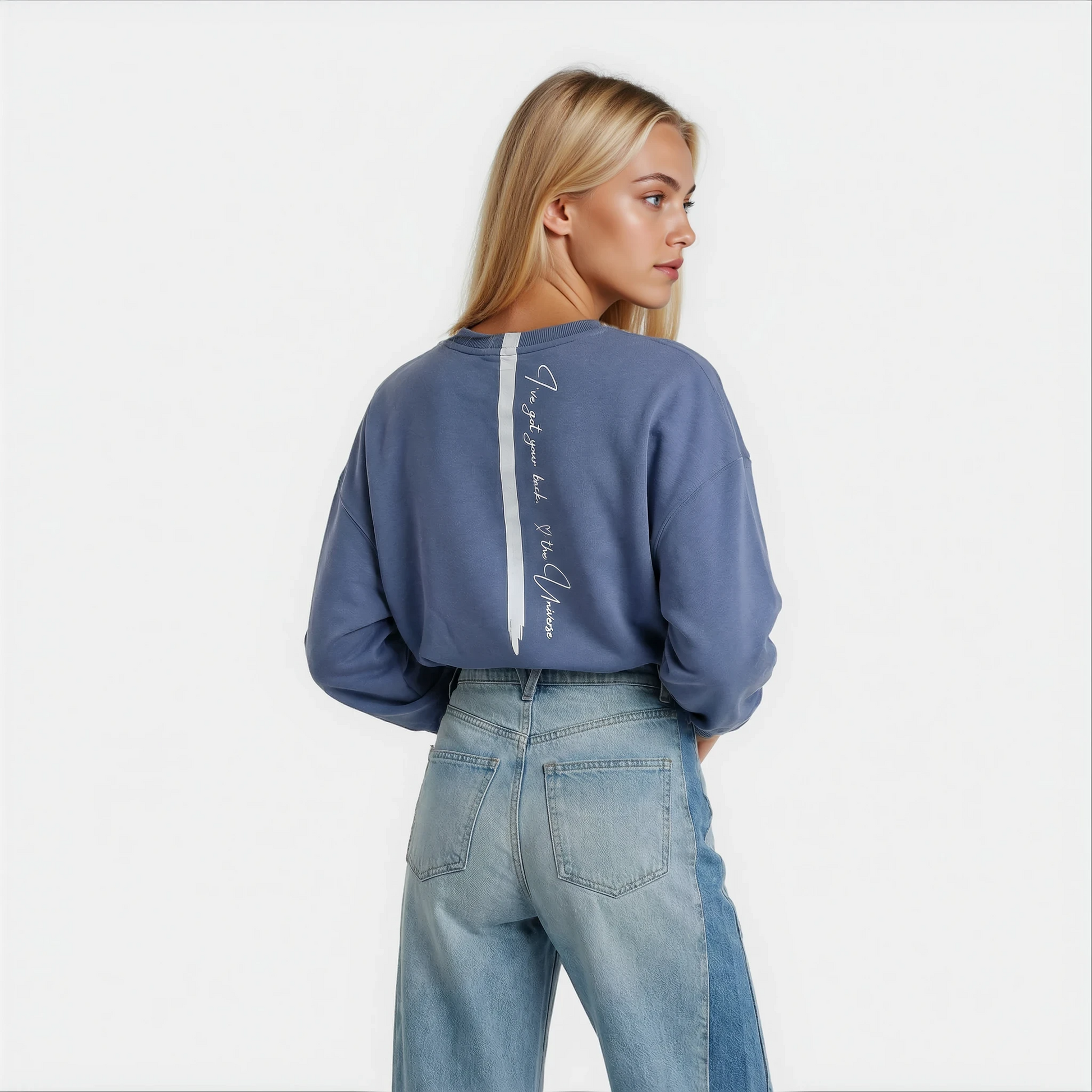 Back view of a woman wearing a super cute printed blue sweatshirt by House of Malibu.