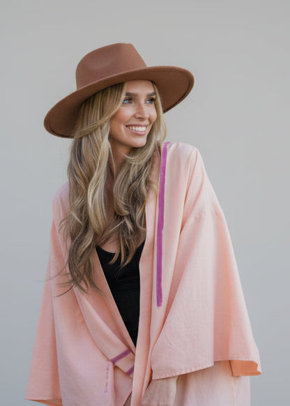 Woman wearing a house of malibu hand-painted peach kimono  open and long  
