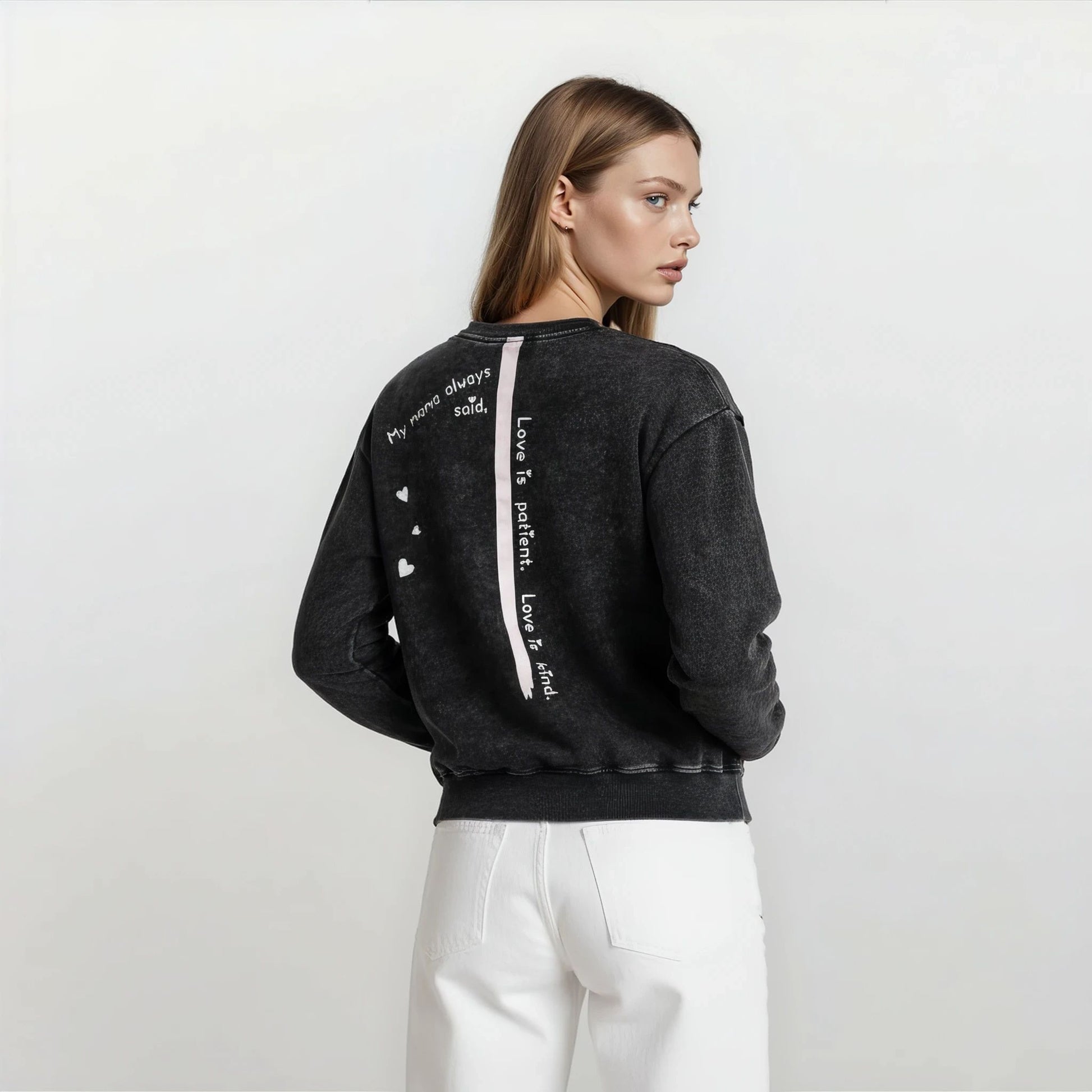 Side angle of Onyx Wash oversized boyfriend cotton sweatshirt showing spine stripe and quote and its relaxed fit.