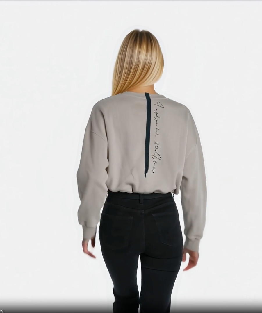 video of a woman walking away showing off her cropped sandstone affirmation cotton sweatshirt with a quote down the back
